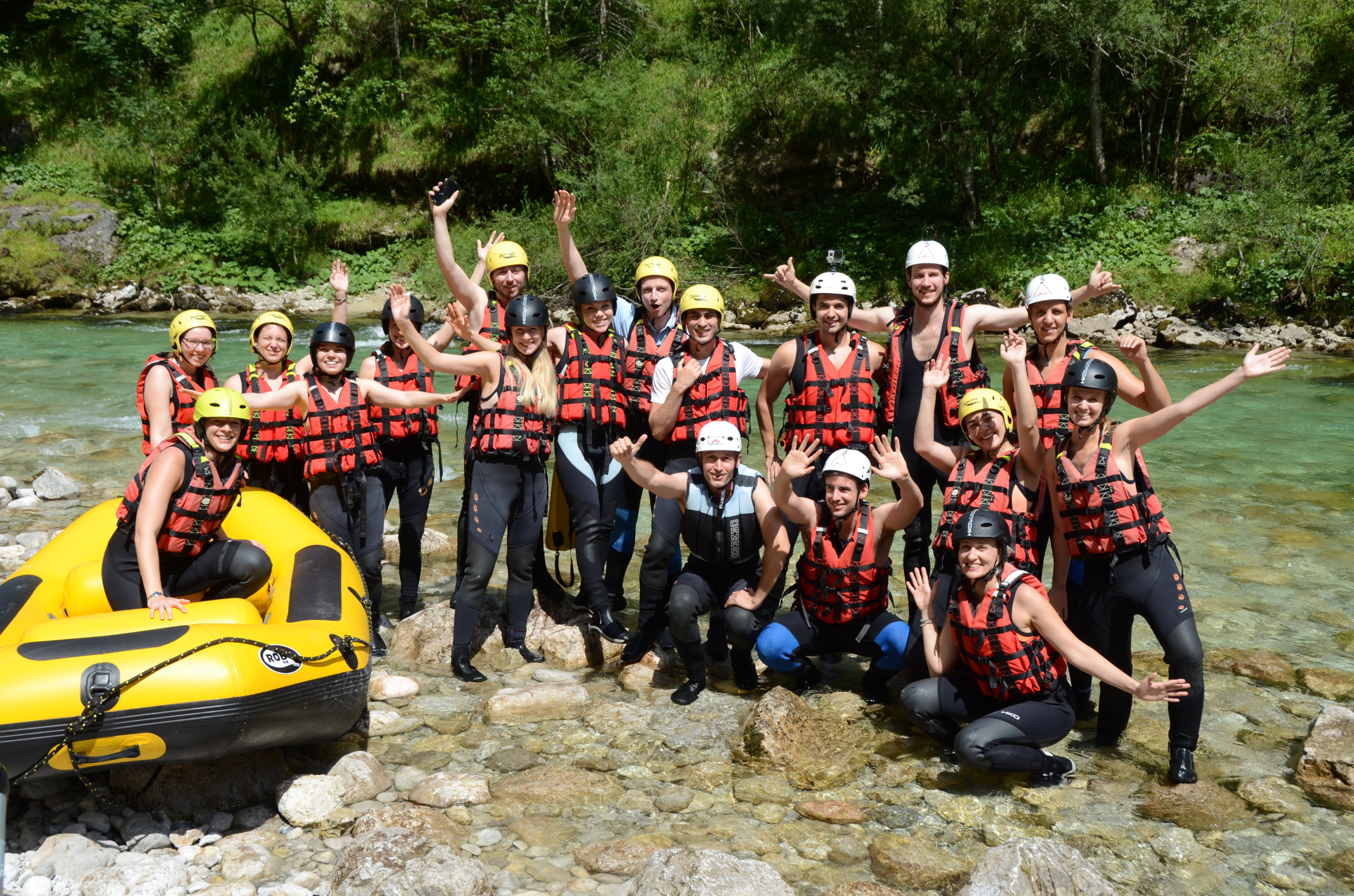A group picture of the checkyeti team during rafting in the Nationalpark Gesäuse in Austria during a summer team event.
