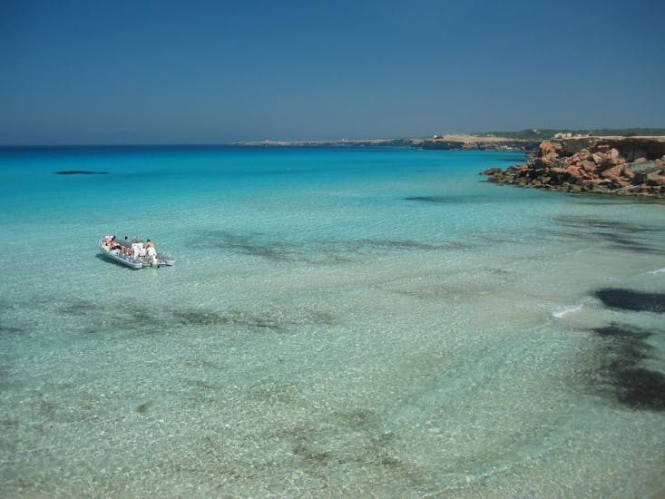 Our boat awaiting for you to do snorkeling in the beautiful island of Formentera with La Isla Flotante.