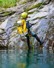 Person coming out of the water during canyoning.