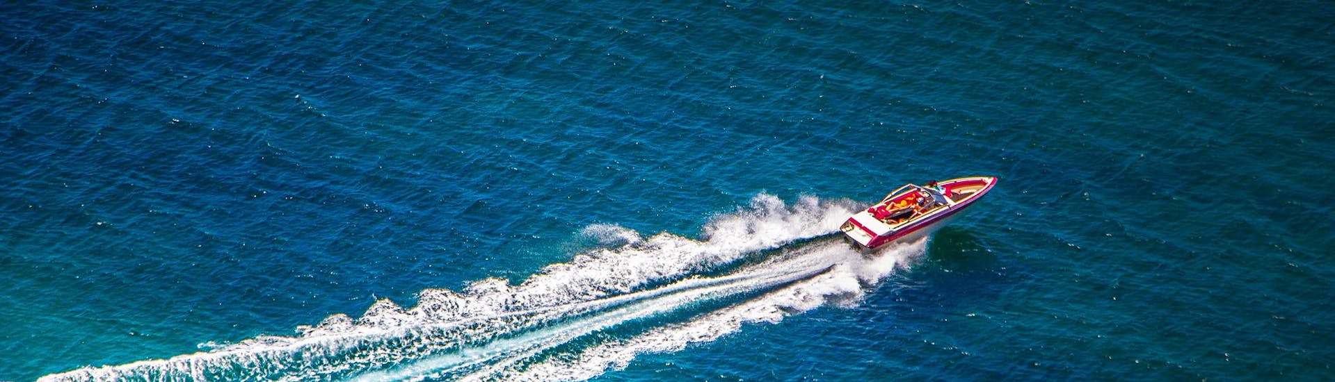 A speedboat going fast during a trip.
