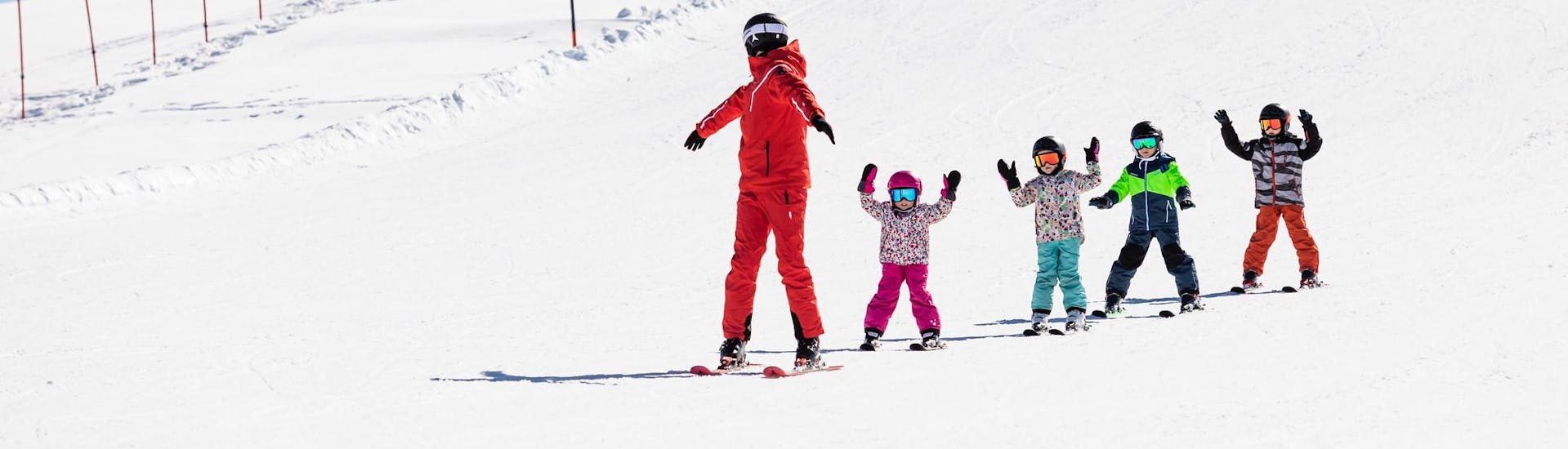 Ski instructor and kids enjoy a ski lesson with a ski school near Schönberg im Stubaital.