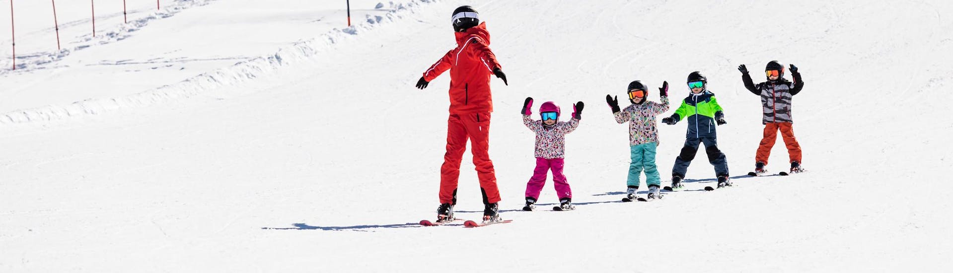 Ski instructor and kids enjoy a ski lesson with a ski school near Straubing.