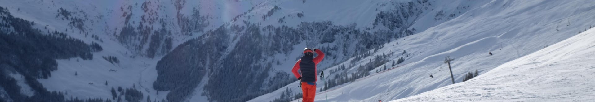 Adults and kids skiing in Alpbach ski resort.