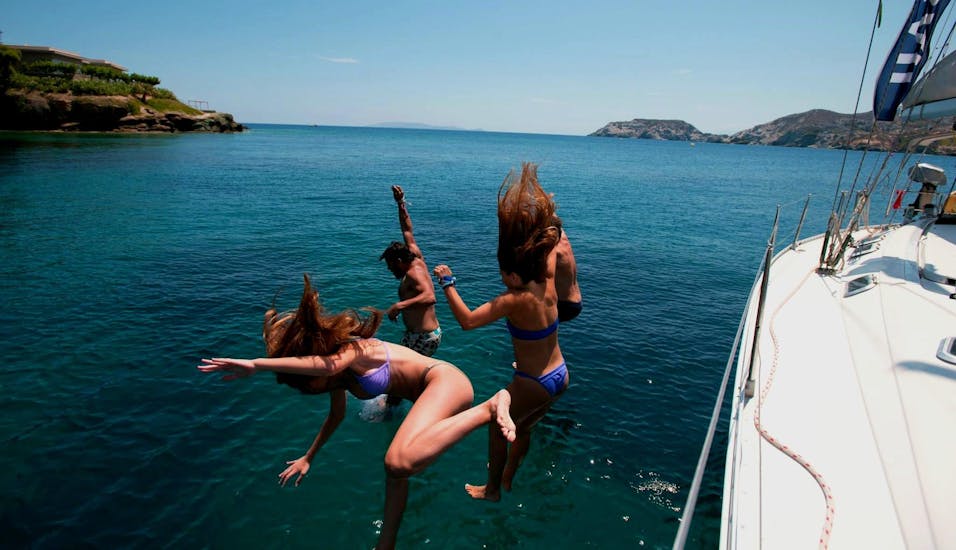 Group of friends jumping from Altersail's boat during a boat trip to Dia from Heraklion.