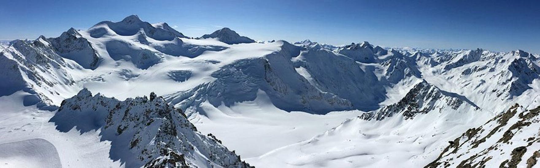 Ein Panoramablick über die schneebedeckten Berge des Skigebiets Arosa - Lenzerheide in den Schweizer Alpen, wo die ACT Sports Skischule Arosa private Skikurse für Kinder und Erwachsene anbietet.