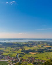 The view from above from the Chiemsee in an hot air balloon that you will have during your ballooning flight.