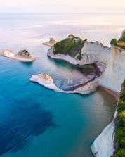 An image of Cape Drastis with its white cliffs, a popular sight during many boat tours on Corfu.
