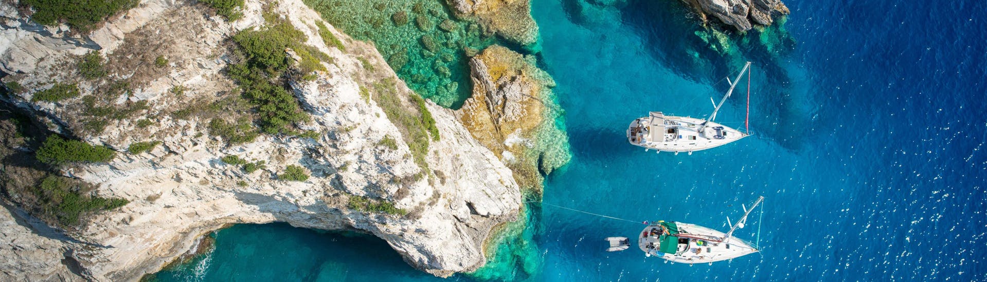 Aerial view of a cove on the island of Antipaxos where boats are moored, a popular destination in Greece for boat trips.