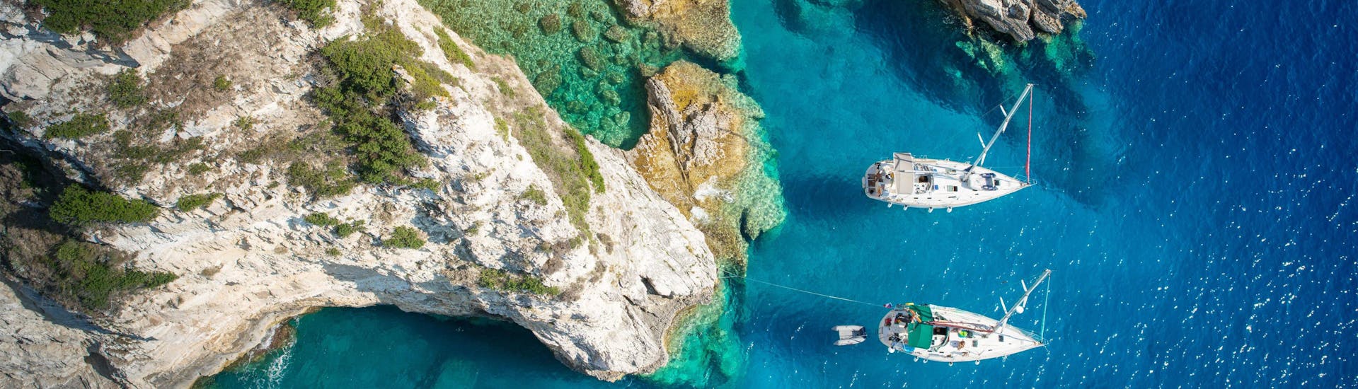 Aerial view of a cove near the blue lagoon beach where boats are moored, a population destination in Greece for boat trips.