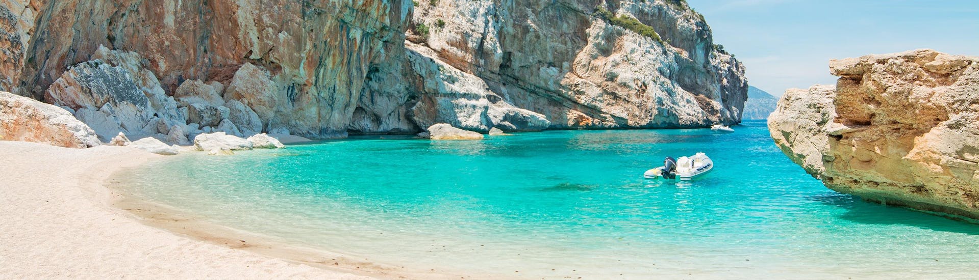 Ein schöner Strand an der Küste Sardiniens, den man während einer Bootstour aus besuchen kann.