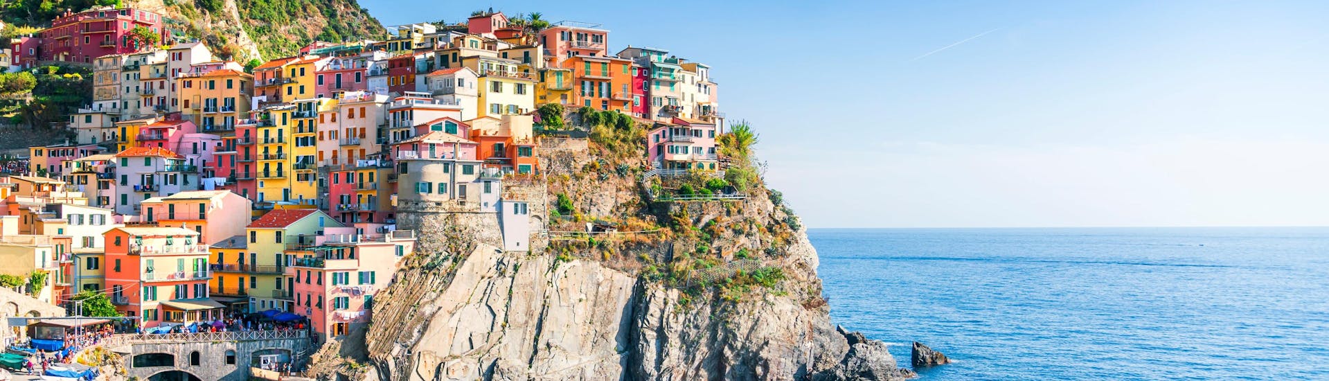 An image of the picturesque little village of Manarola perched on top of the cliffs on the Cinque Terre coast, one of the sights afforded to those who go on a boat trip from Monterosso al Mare.