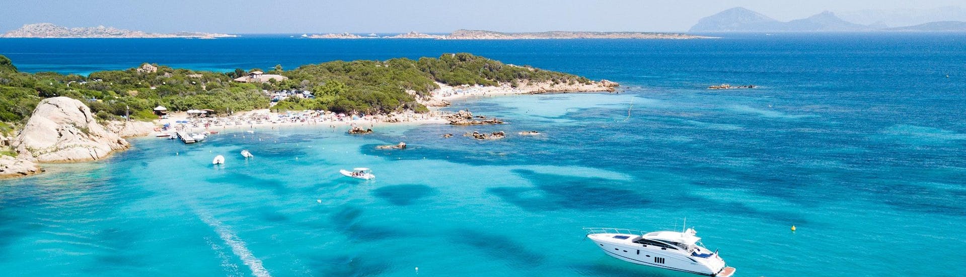 View of two boats cruising along the Costa Smeralda, where a lot of boat trips in Sardinia take place.