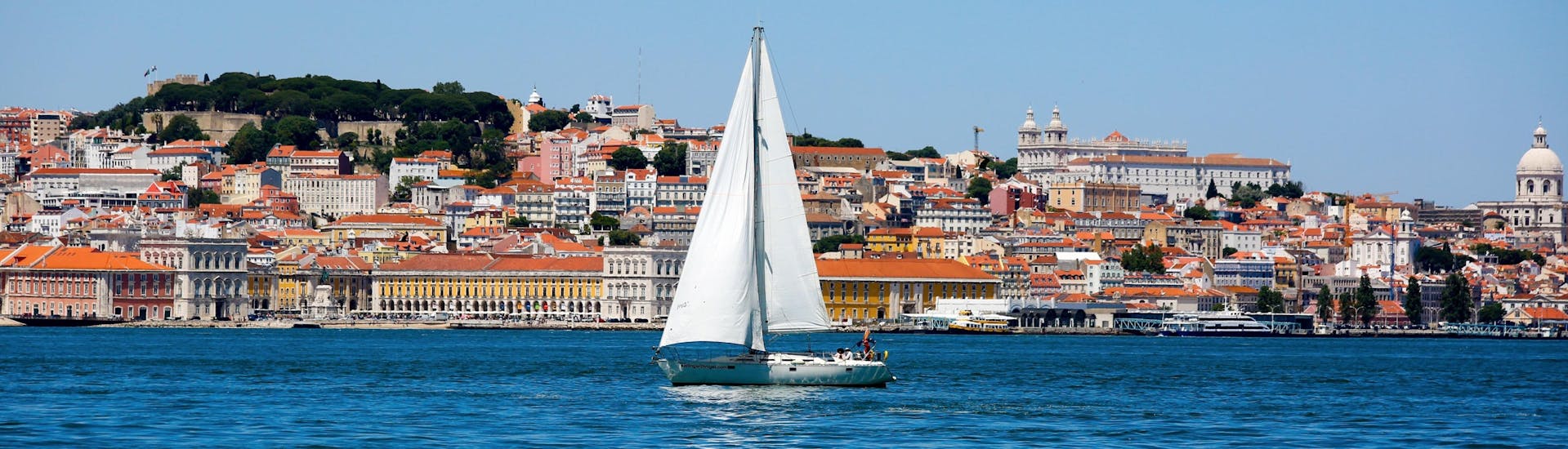 An image of a sailing boat drifting along the Tagus River during a boat trip in Lisbon.