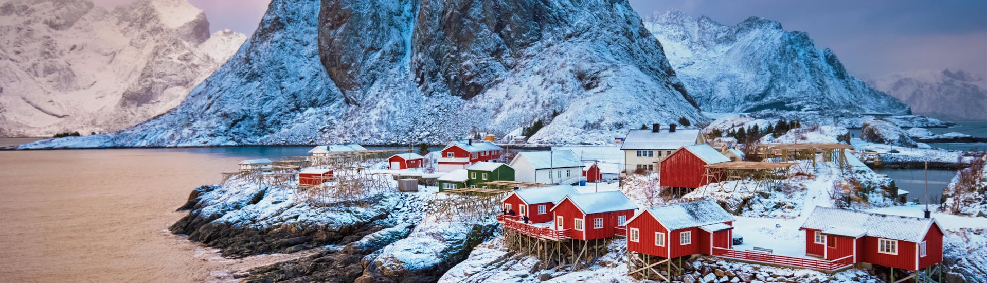 View of a small fishing village on the Lofoten Islands in Arctic Norway, where boat trips allow visitors to marvel at the spectacular fjords.