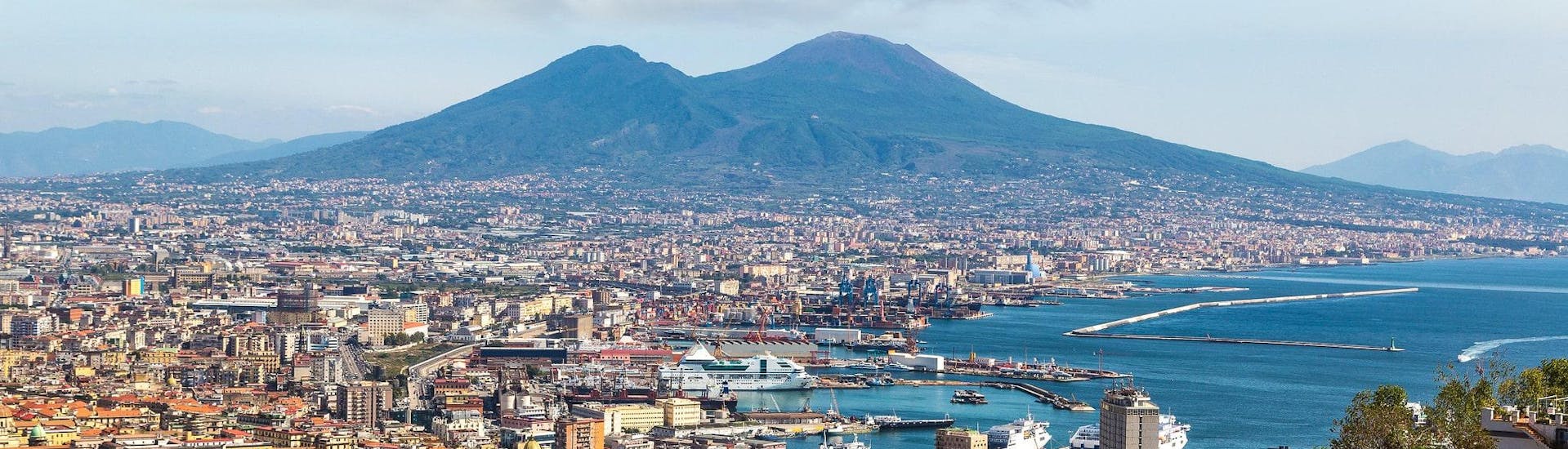 View of the city of Naples with Mount Vesuvius in the background, from where many boat trips to Capri and the Amalfi Coast start.