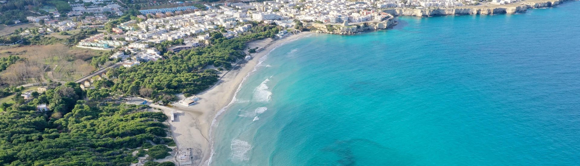 View of a stunning beach in Salento, Puglia, where providers offer boat trips.