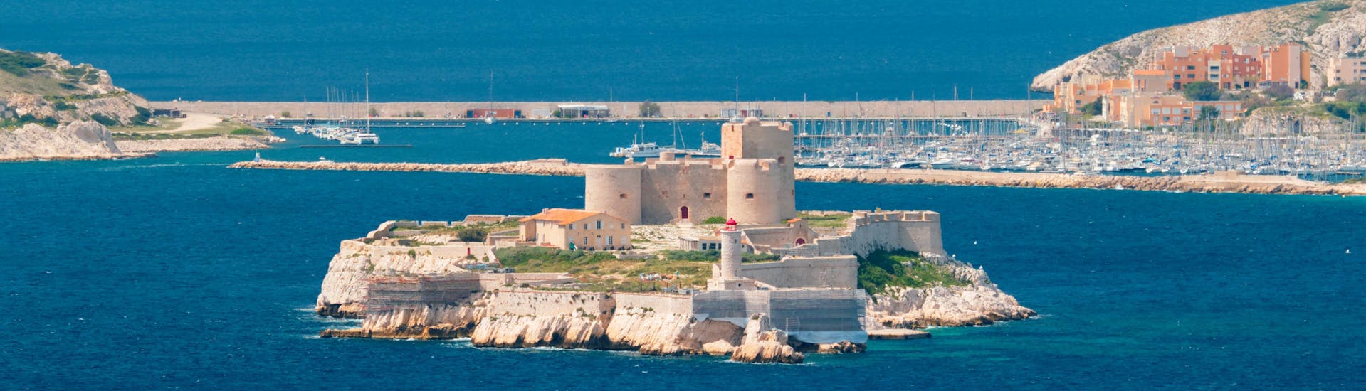 A boat is sailing past Château d'If, which can be visited on many boat trips from Marseille.