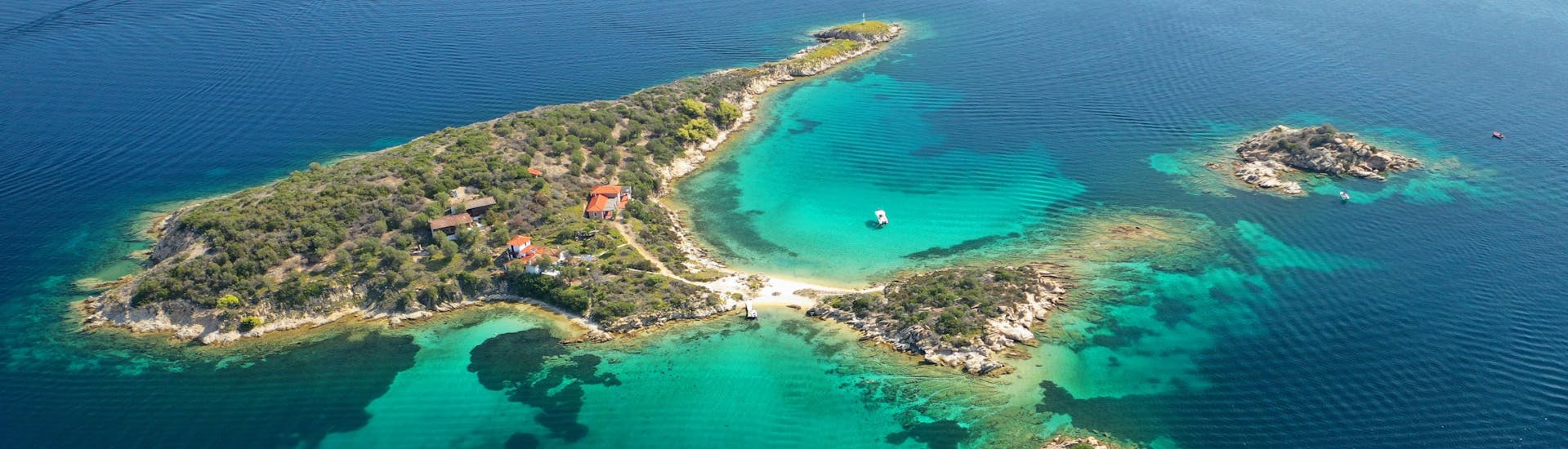 Foto panorámica aérea con dron del emblemático islote de Peristeri con un mar turquesa cristalino cerca de la isla de Diaporos.