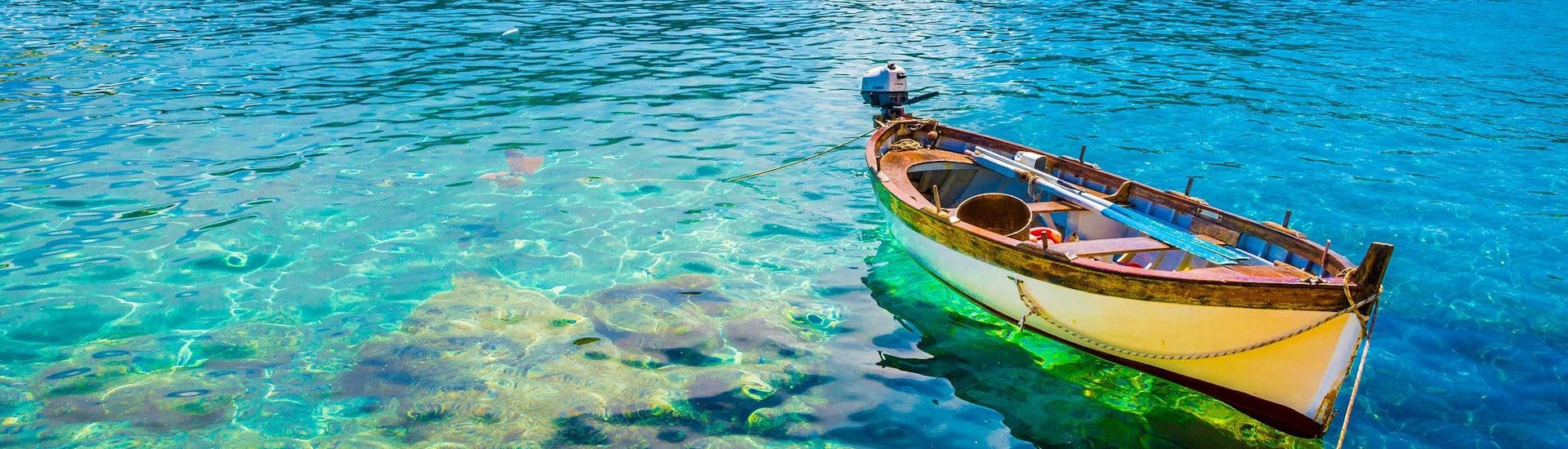 A boat is floating in the clear waters of fetovaia which is a popular destination for boat trips.