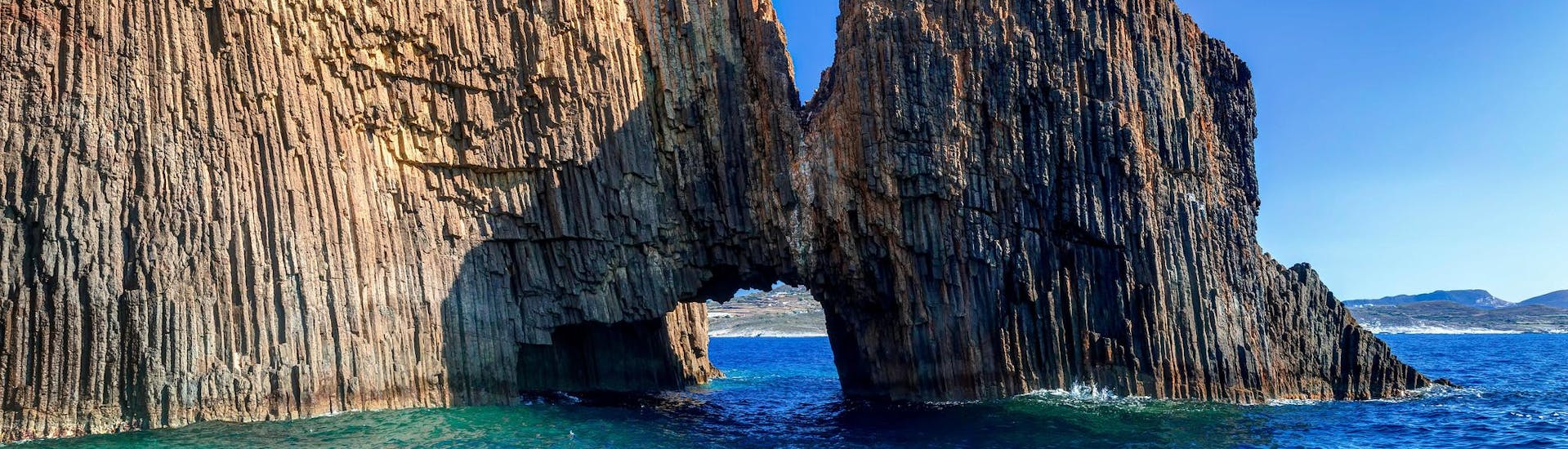 Unbelievable rocky volcanic Glaronissia islets with a beautiful arch, that you can see with a boat trip in Milos island.