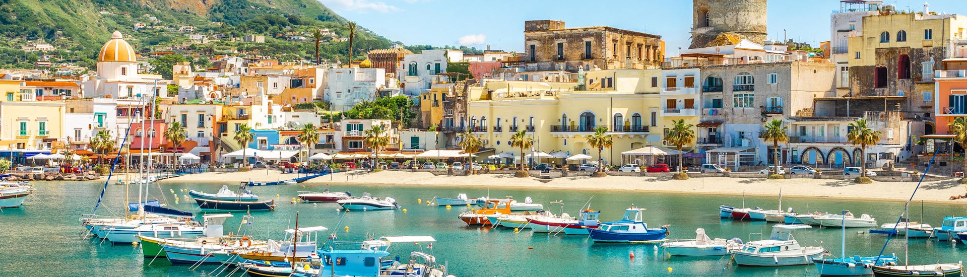View of a beautiful seashore town in Ischia where boat providers offer their tours. 