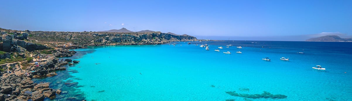 Boat Trips to Favignana Island SEM Hero Several boats near the coast during a boat trip to Favignana Island.