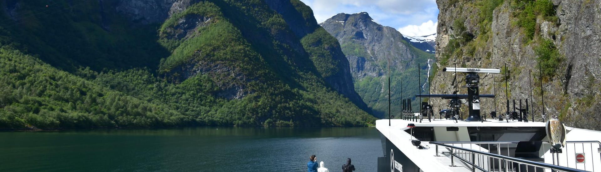 People visiting a fjord during a boat trip.