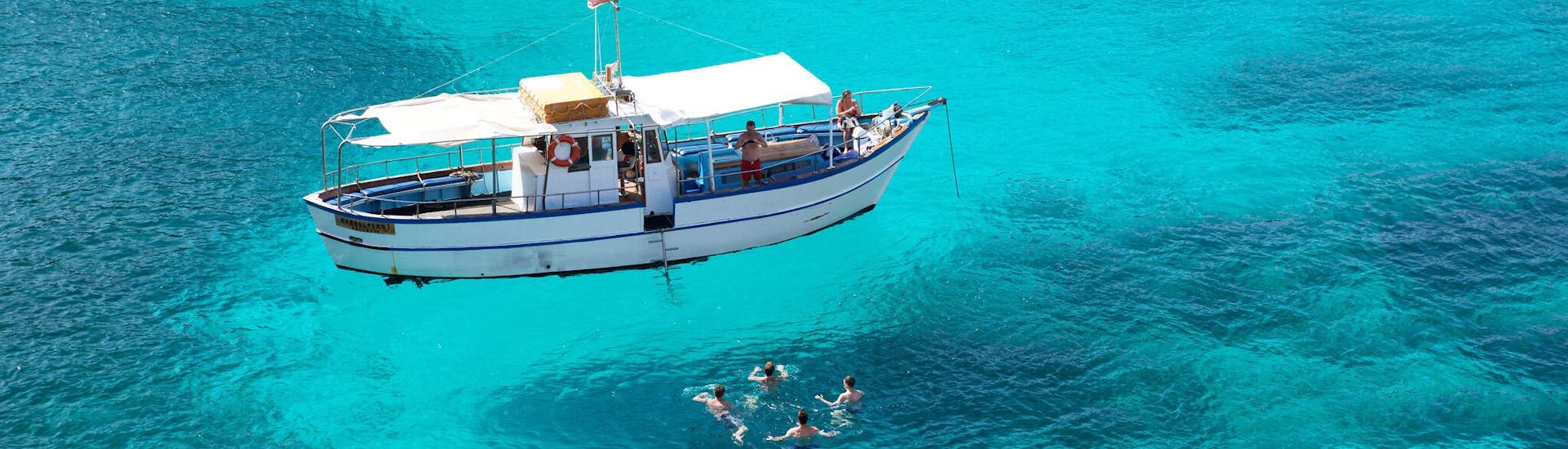 People having fun in a lagoon during a stop in their boat trip.