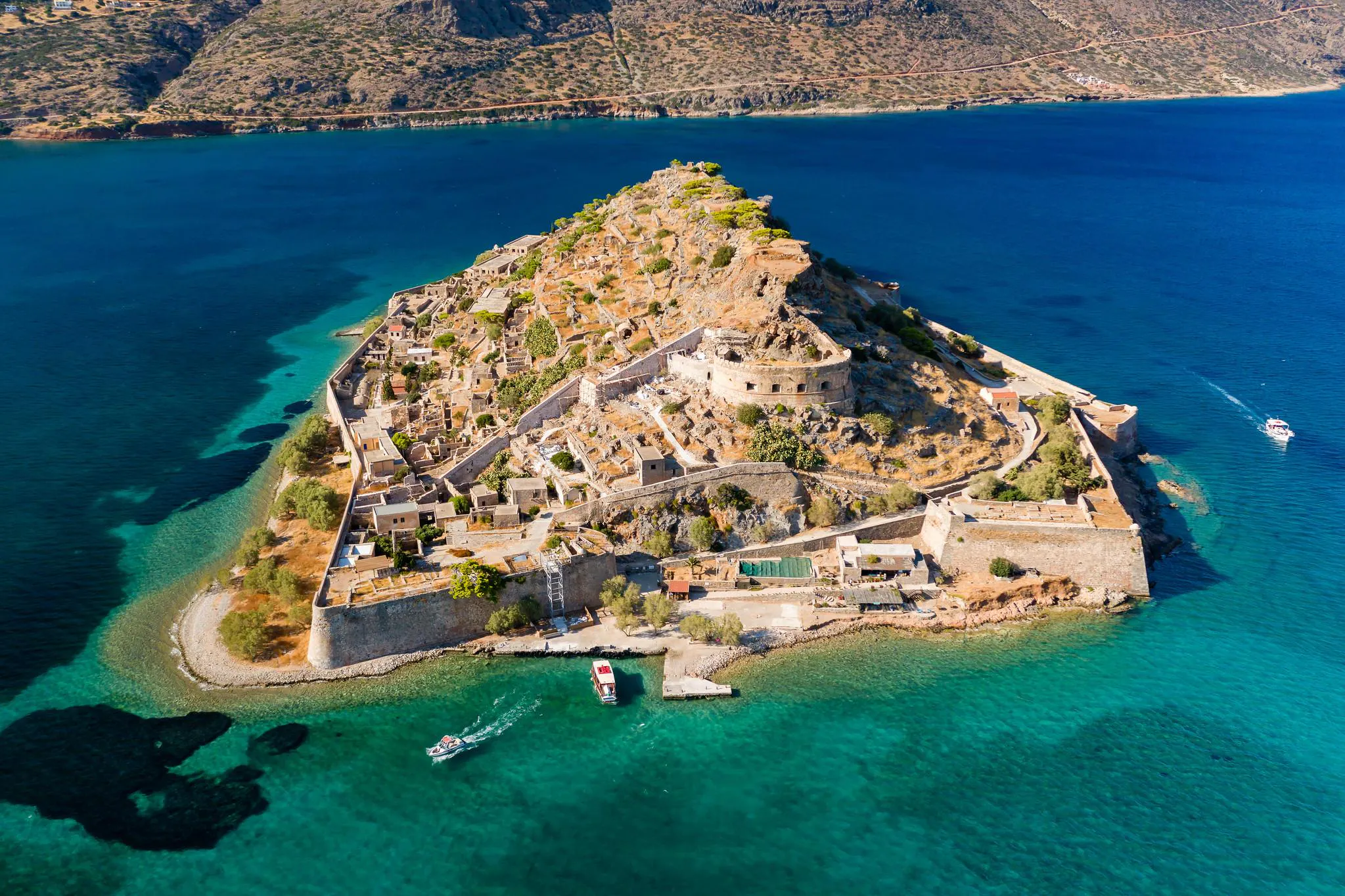 Several boats near the coast during a boat trip to Spinalonga.