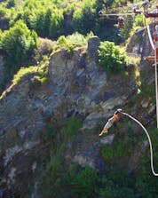 A brave young man is leaping into the depths of the canyon while bungee jumping at Gorges du Tarn.