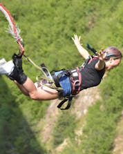 A very brave woman in the middle of a bungee jump in Interlaken.