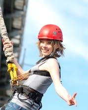 A woman smiling before doing her bungee jumping in Galicia.