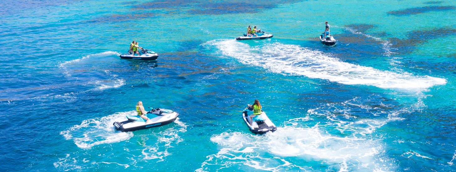 A group of people riding a jetski in the sea in Cala d'Or.