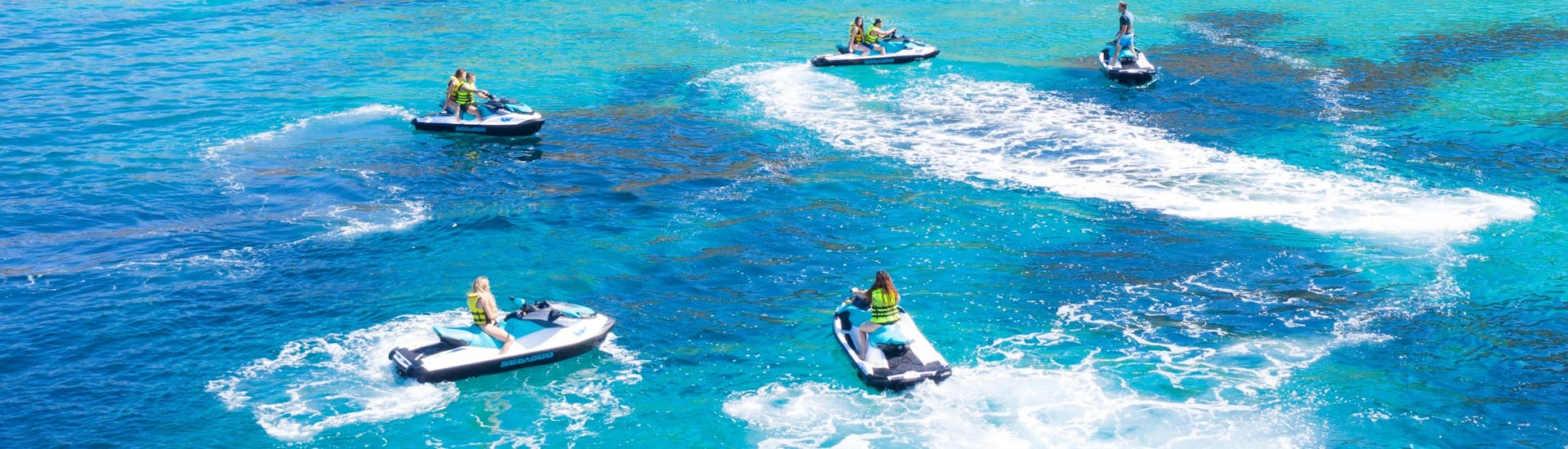 A group of people riding a jetski in the sea in Cala d'Or.