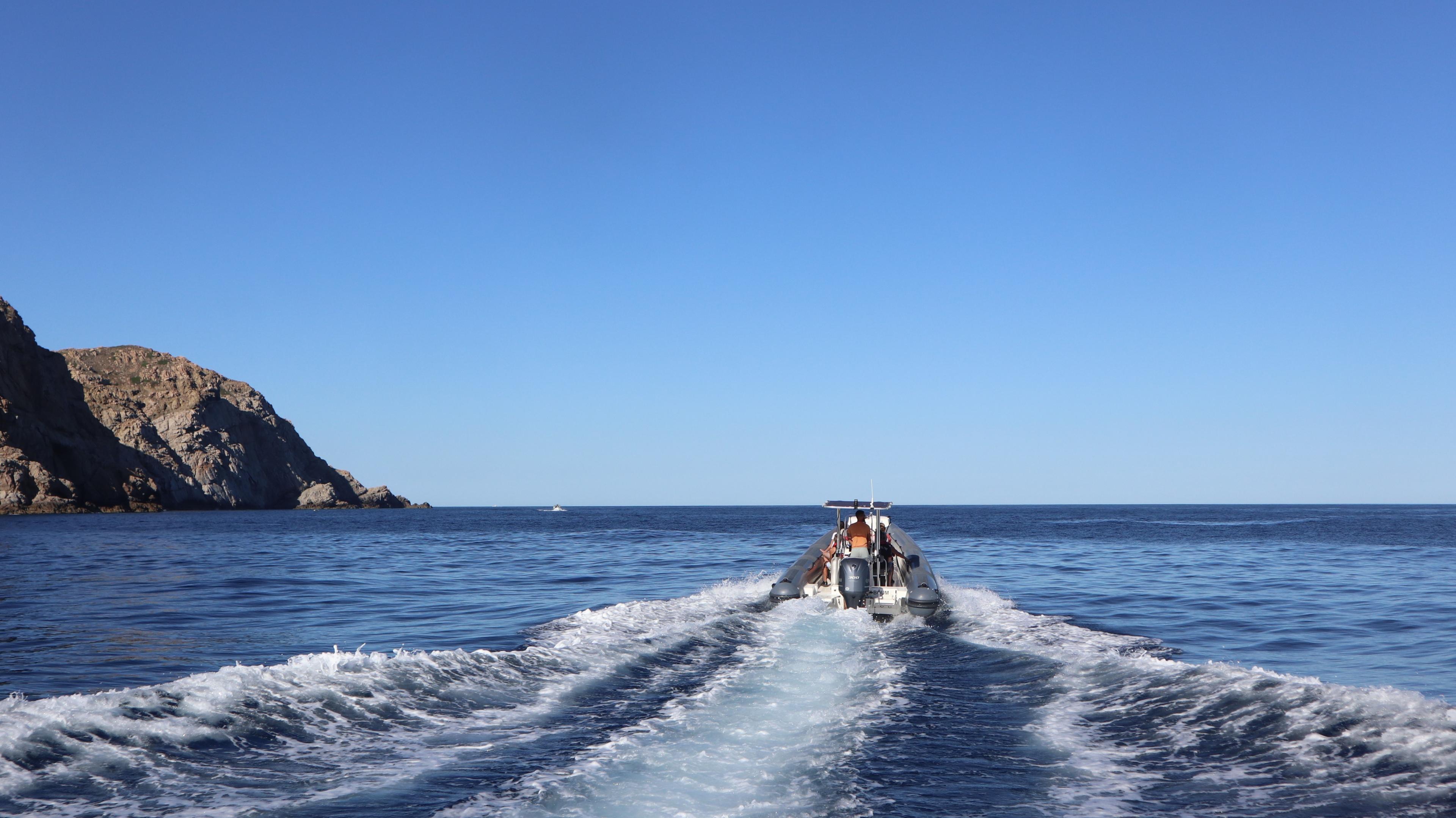 Boat on a trip in the surroundings of Calvi, with Calvi Promenade en Mer.