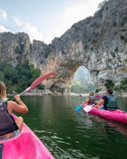A woman has rented a canoe with her friends from Aigue Vive and is descending Mini-Tour 5km in Ardèche.