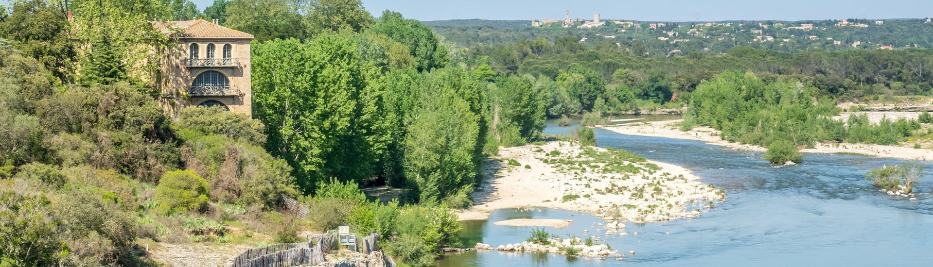 View of the Gardon river passing through Collias, one of the canoeing hotspots in France, allowing you to paddle under the Pont du Gard.