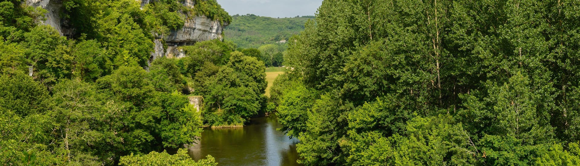 View of the wild Vézère valley in the Dordogne region where tourists enjoy canoeing.