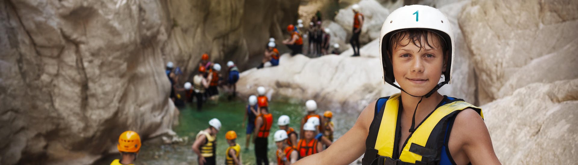 Kids on a canyoning tour for beginners with their family