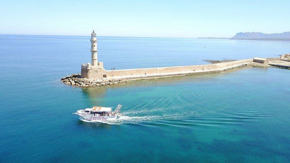 Boat driving past a a lighthouse during a boat trip with Captain Nestor in Chania.
