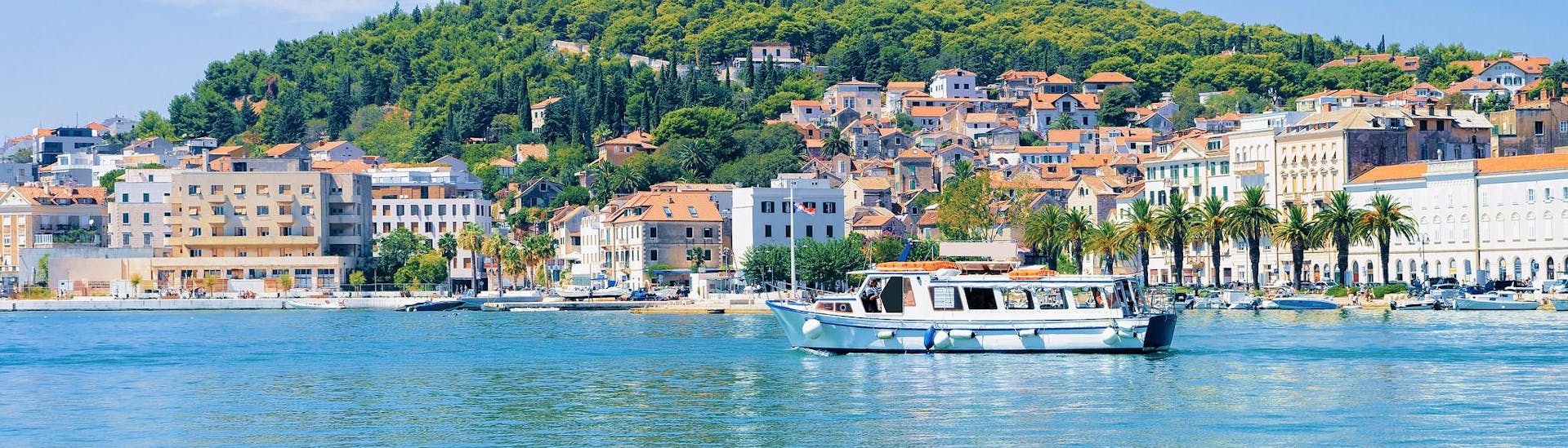 Gente disfrutando de un paseo en barco barato por menos de 30€ cerca de la costa.