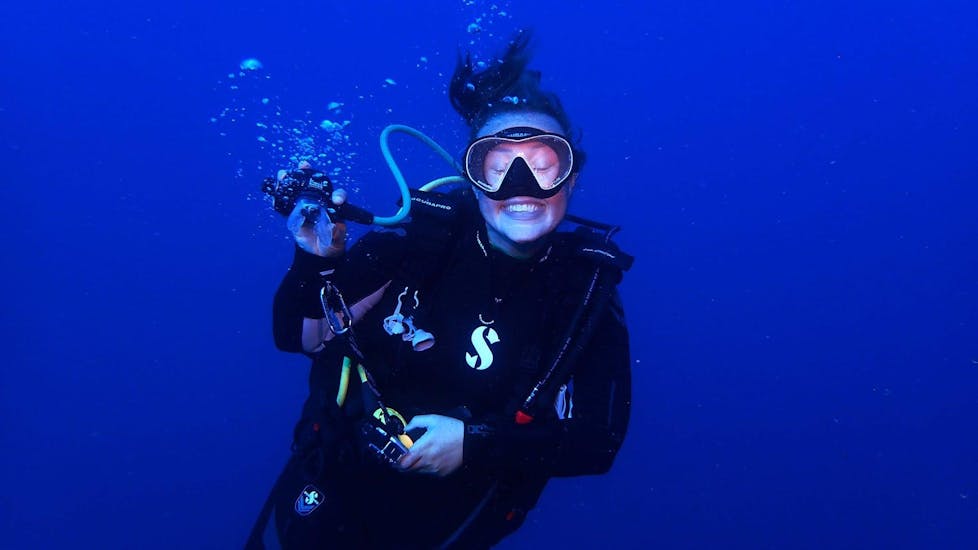 A woman smiling in the camera during her scuba diving lessons with Cydive Paphos.