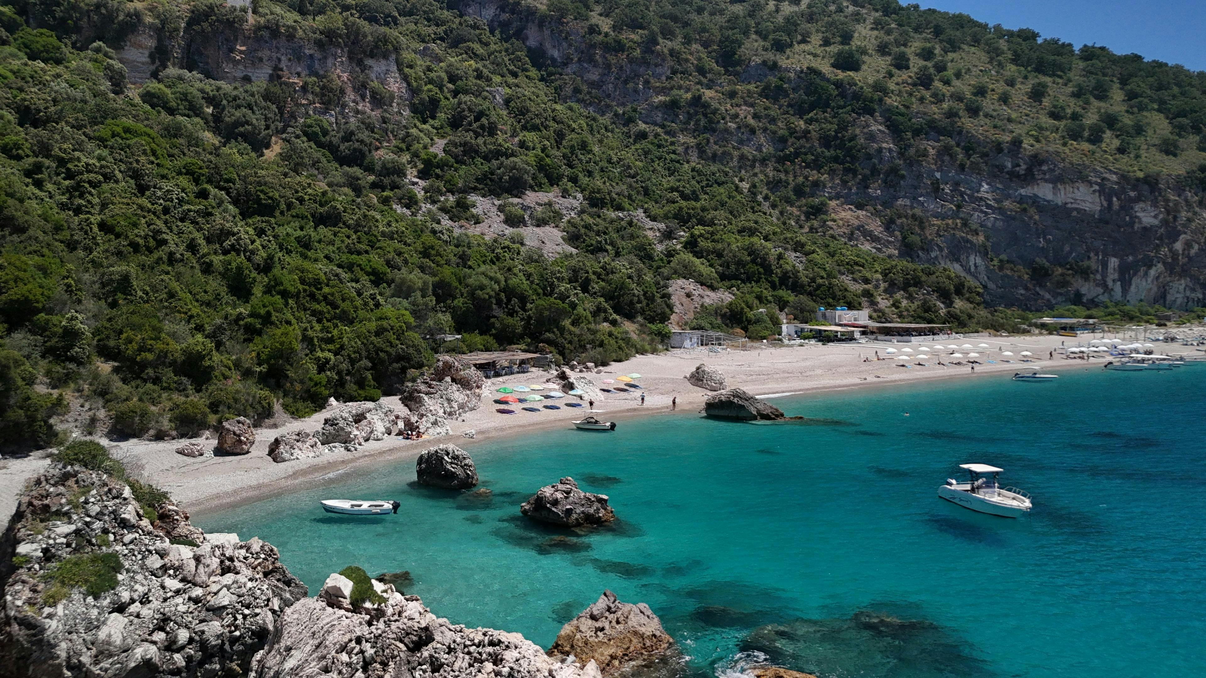 Beautiful landscapes showcasing mountains and sea, where the experiences of Kelvin Boat Trip Saranda are taking place.