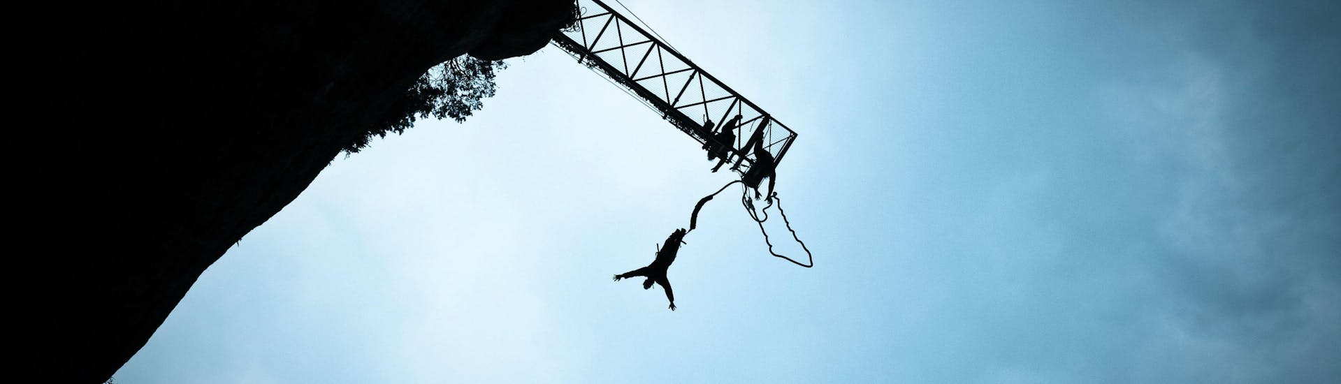 A man is jumping during his Bungee Jumping activity with Elastic Natural Bungee.