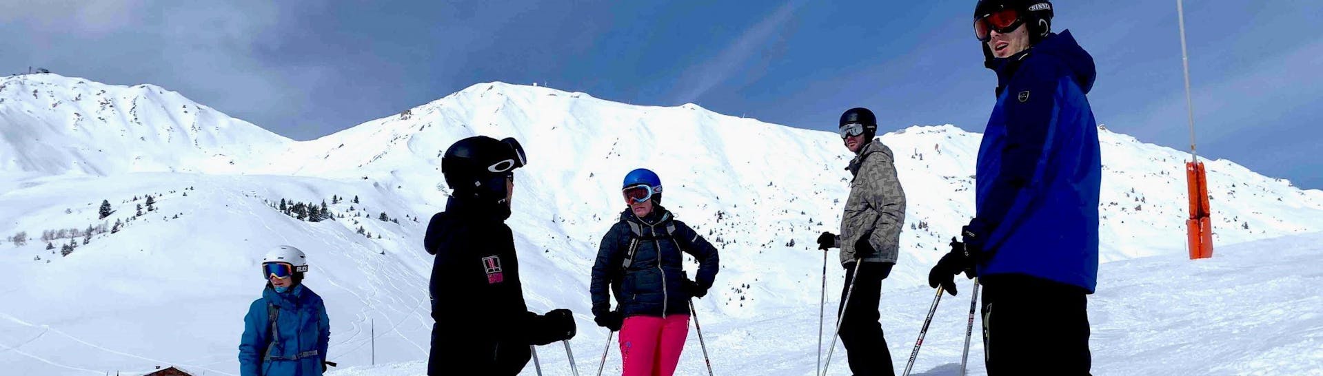 People doing ski lessons with ELPRO Ski School La Plagne.