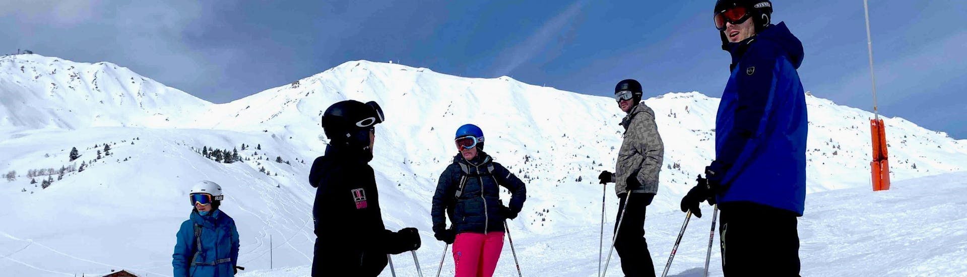 People doing ski lessons with ELPRO Ski School La Plagne.