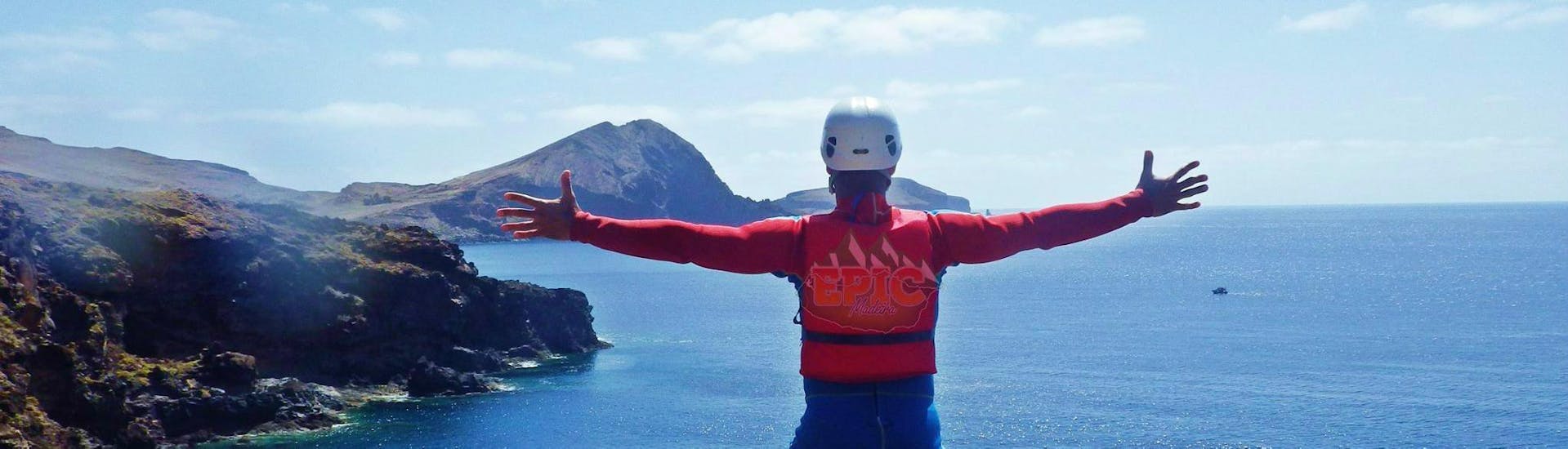 A participant of a coasteering tour with Epic Madeira is enjoying the spectacular view over Madeira's coastline.