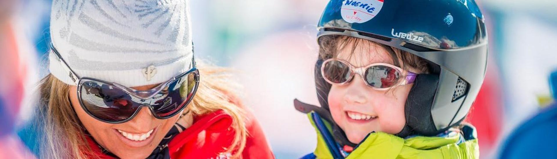 A child is having fun with her private instructor while learning how to ski in the ski school ESF Val d'Isère located in the ski resort Val d'Isère.