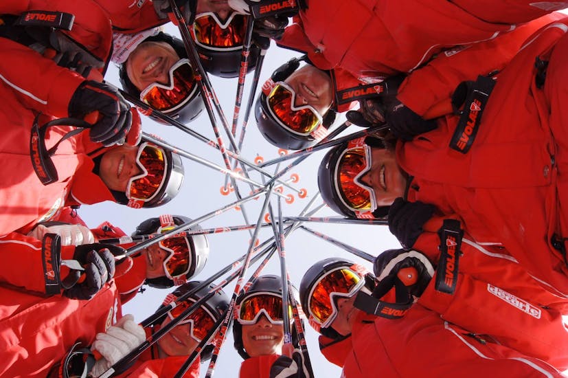 The instructors of the Swiss Ski School La Tzoumaz are gathered together in a circle before the start of the ski lessons.