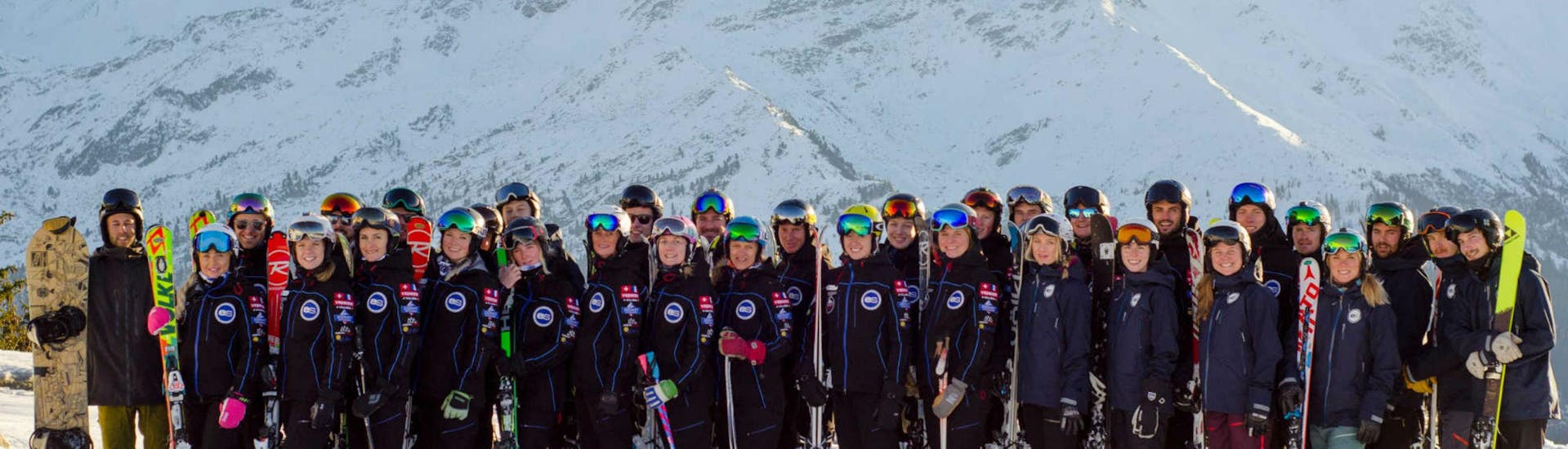The ski instructors from the ski school European Snowsport Chamonix are posing together on top of one of the many pistes in the ski resort of Chamonix.